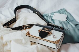 Elegant handbag paired with stylish clothing on a soft backdrop, ideal for fashion inspiration.